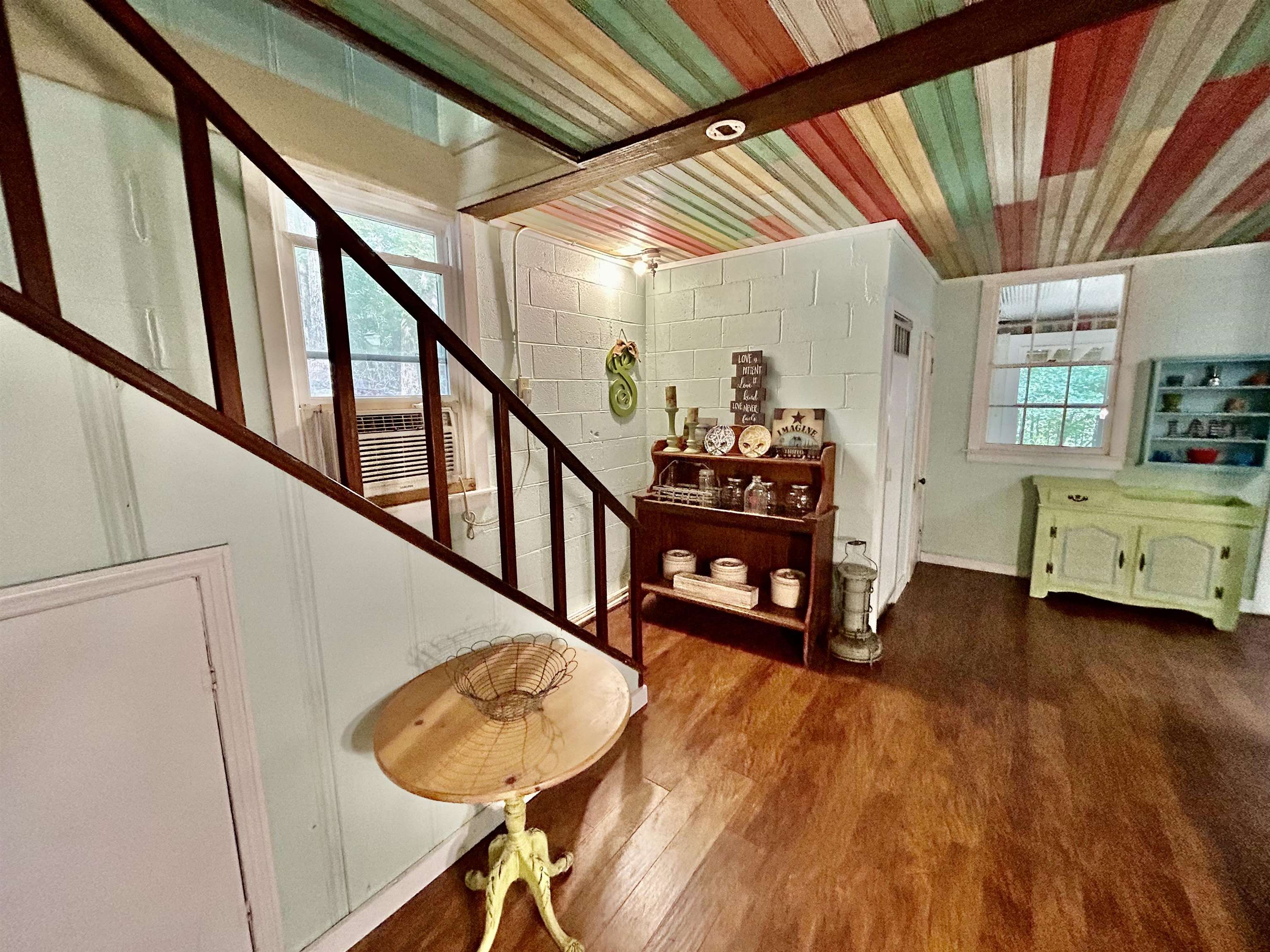 460 Port Lane Counce, TN 38326 - Photo 11 of 23 Stairway with wood finished floors and concrete block wall