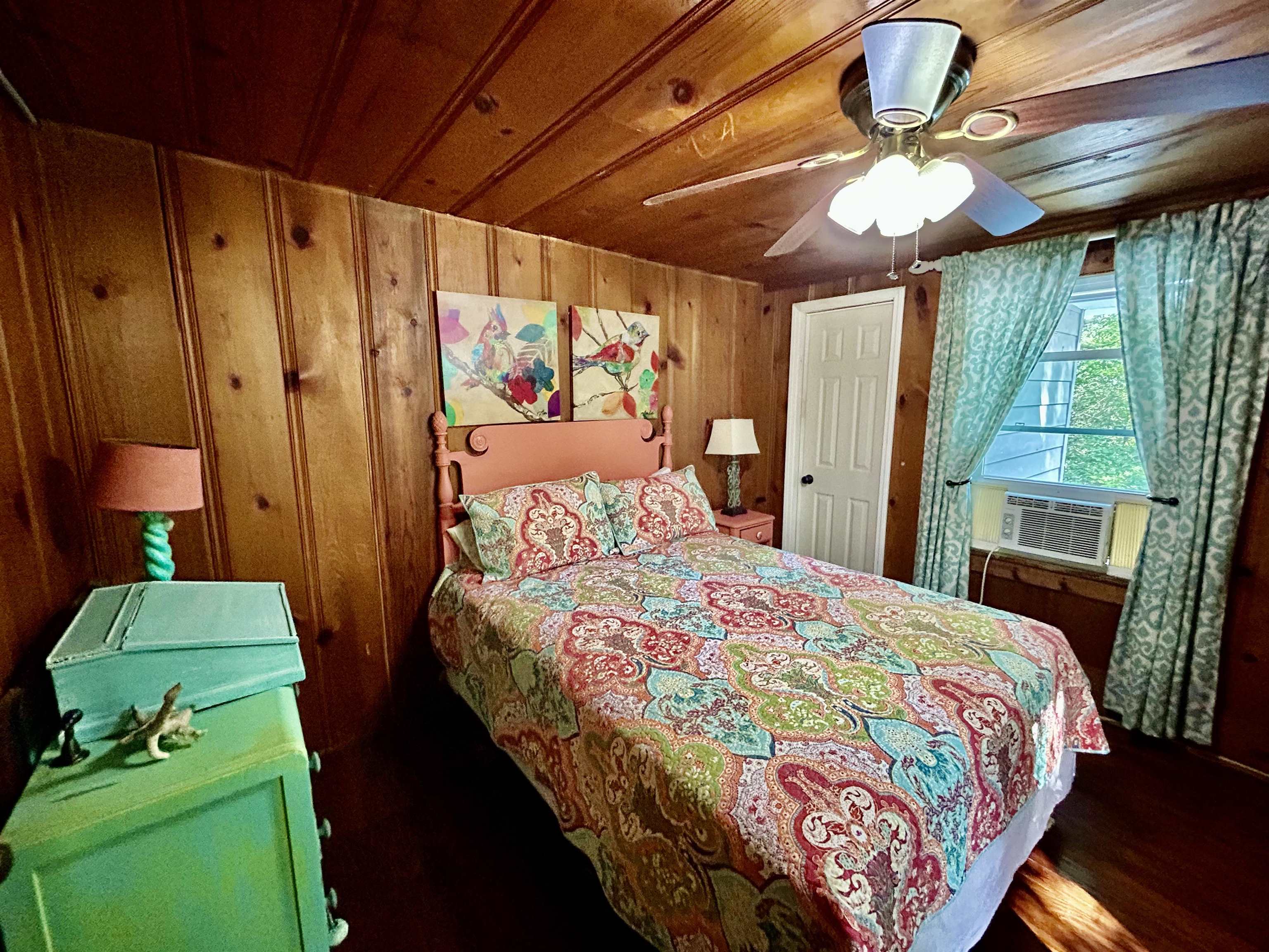 460 Port Lane Counce, TN 38326 - Photo 14 of 23 Bedroom with wooden walls, ceiling fan, wooden ceiling, and dark wood-style floors