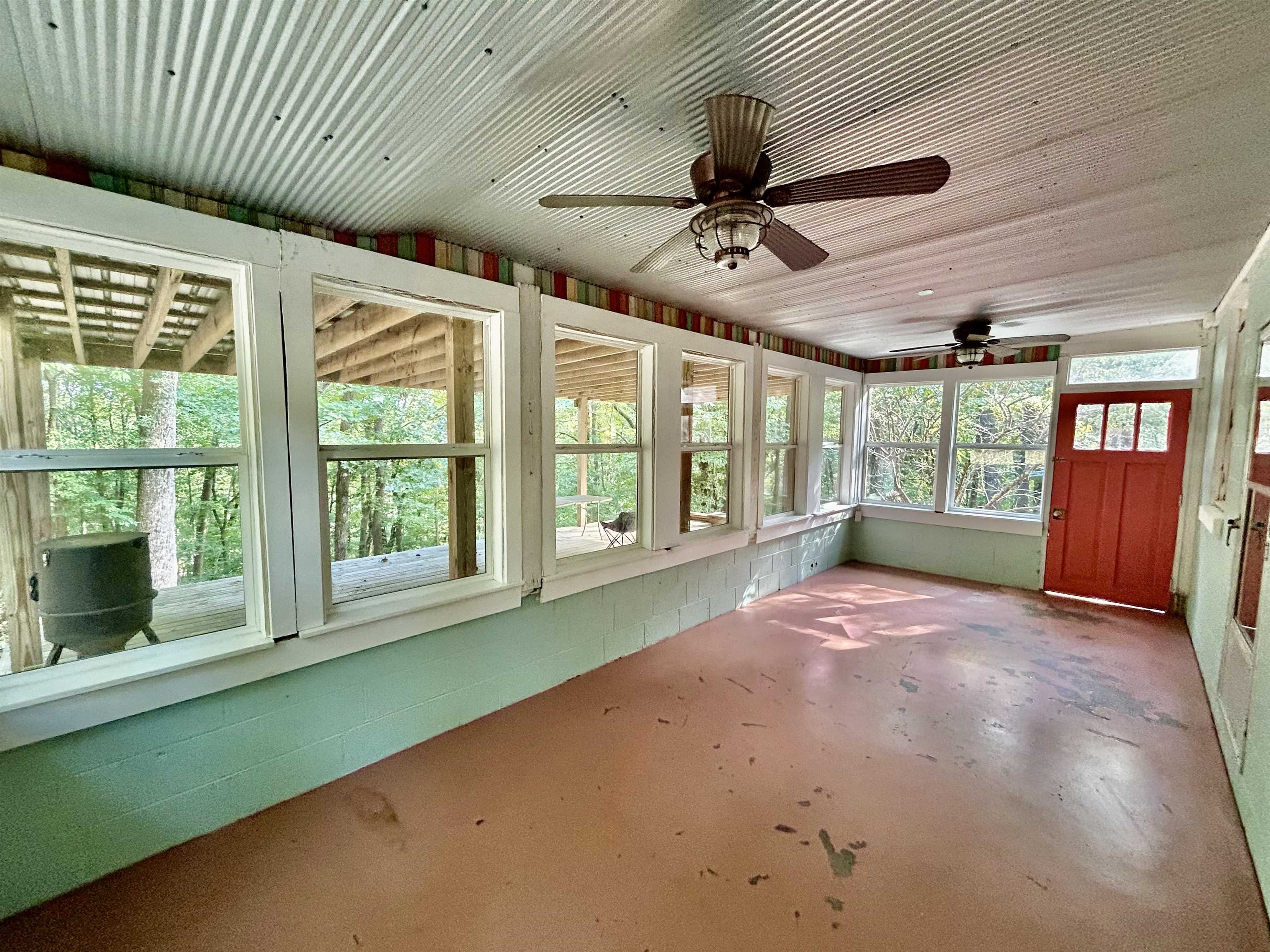 460 Port Lane Counce, TN 38326 - Photo 20 of 23 Unfurnished sunroom with concrete floors, ceiling fan, and concrete block wall