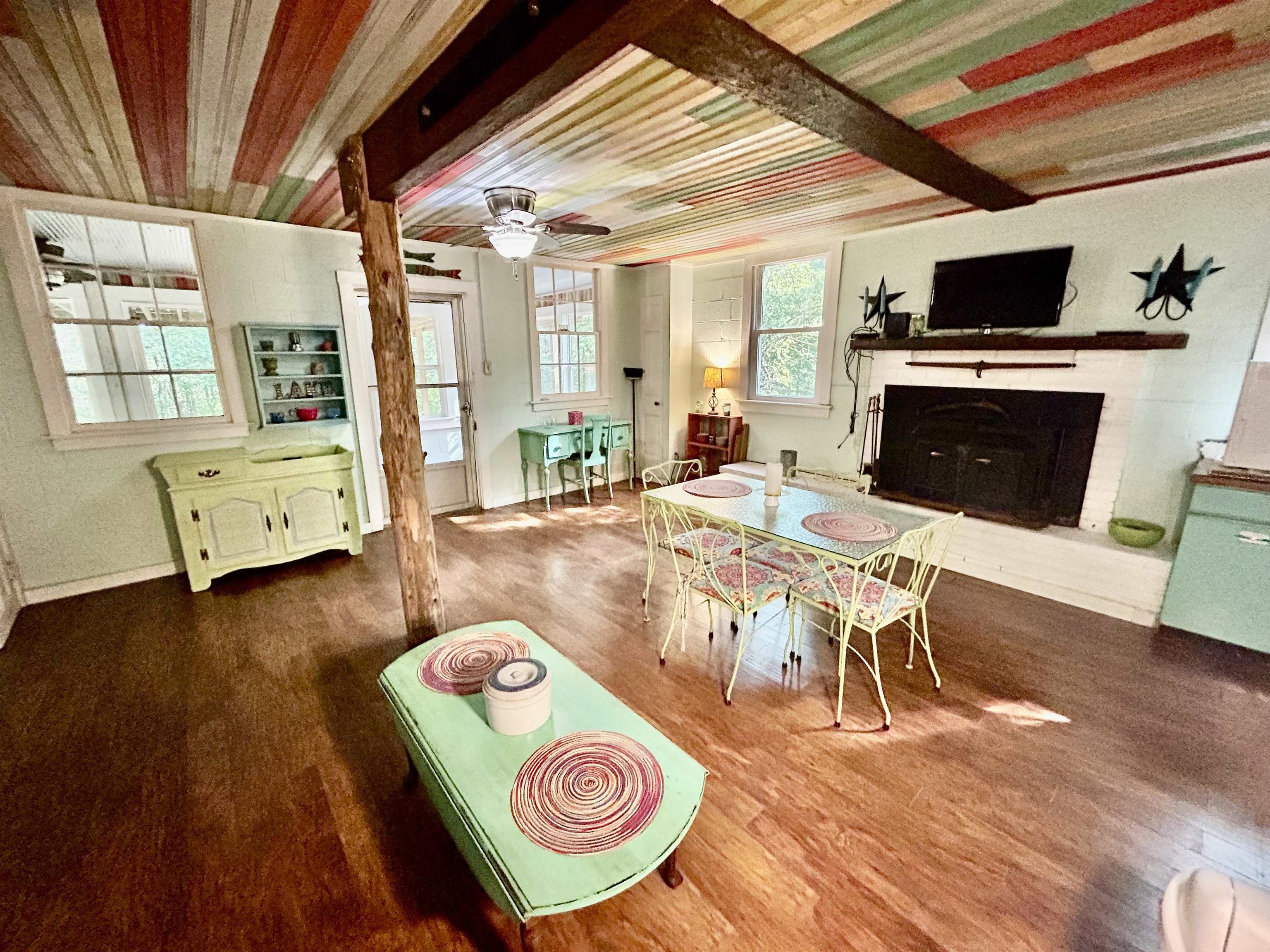 460 Port Lane Counce, TN 38326 - Photo 6 of 23 Game room featuring wood finished floors, a fireplace with raised hearth, and ceiling fan