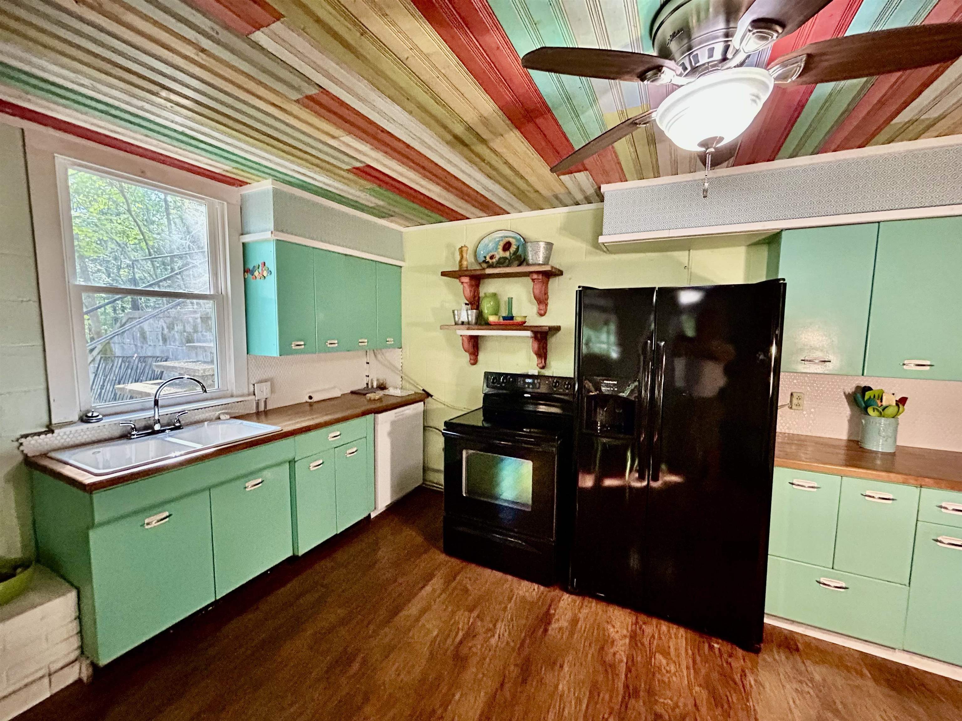 460 Port Lane Counce, TN 38326 - Photo 7 of 23 Kitchen featuring green cabinetry, black appliances, dark wood-style floors, open shelves, and a ceiling fan