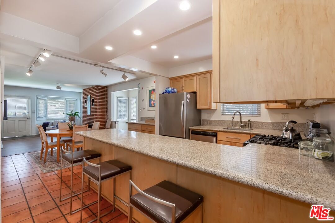 27 Buccaneer Street Marina del Rey, CA 90292 - Photo 13 of 15 a large kitchen with stainless steel appliances a large counter top a stove and a sink