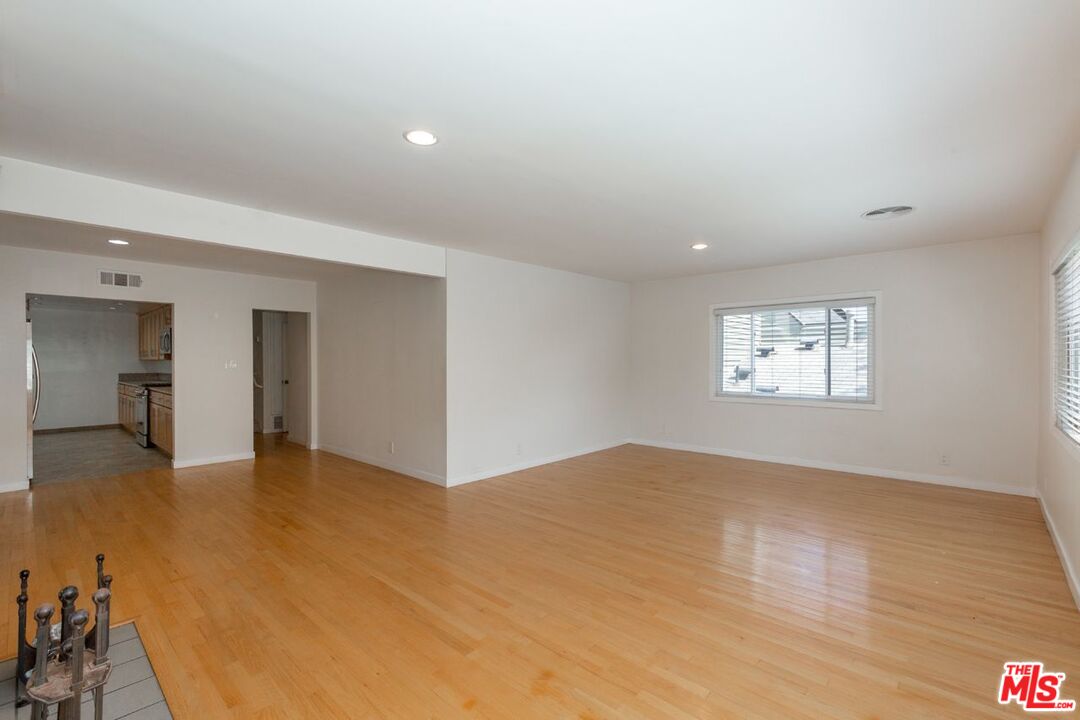 27 Buccaneer Street Marina del Rey, CA 90292 - Photo 3 of 15 an empty room with wooden floor and windows