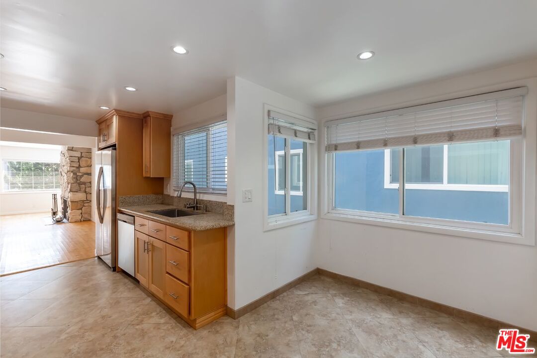 27 Buccaneer Street Marina del Rey, CA 90292 - Photo 6 of 15 a kitchen with stainless steel appliances granite countertop a stove and a refrigerator