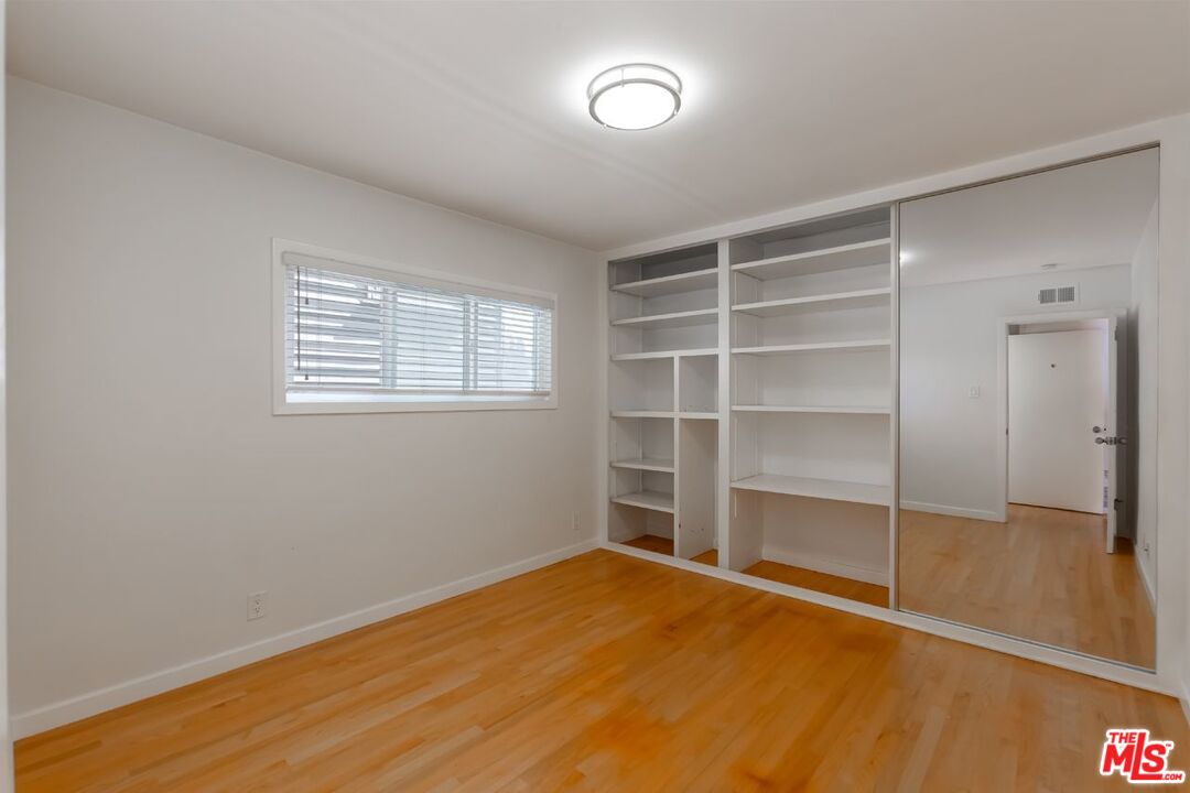 27 Buccaneer Street Marina del Rey, CA 90292 - Photo 8 of 15 a view of an empty room with a window and wooden floor