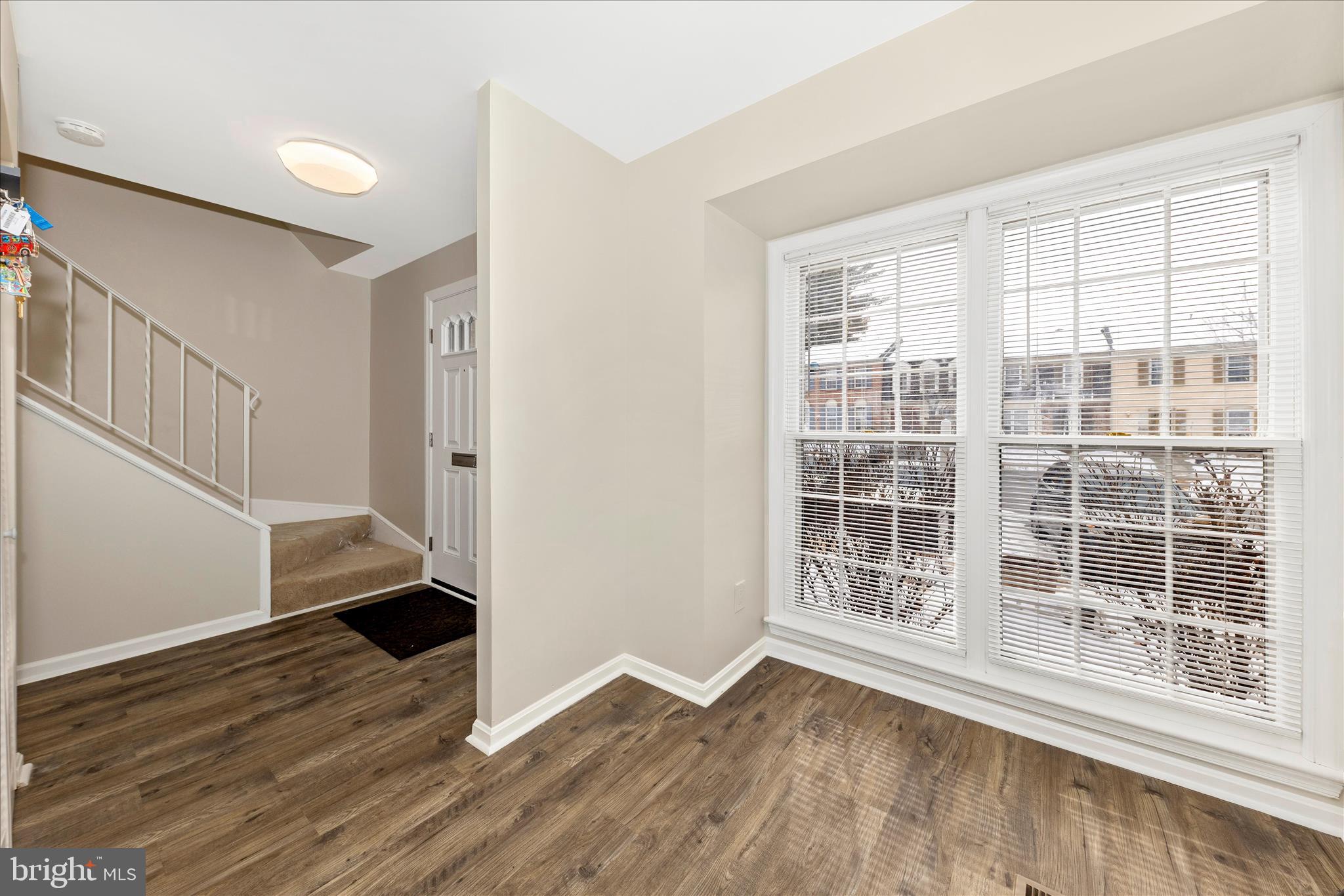 9923 Maple Leaf Drive Gaithersburg, MD 20886 - Photo 8 of 38 an empty room with wooden floor and windows