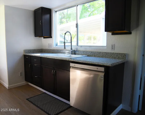 a kitchen with a sink and a window