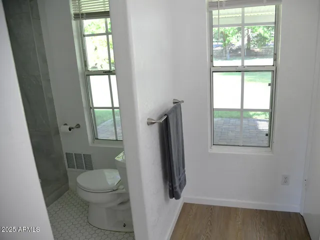 a bathroom with a toilet and a shower