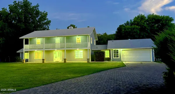 a front view of house with yard and green space