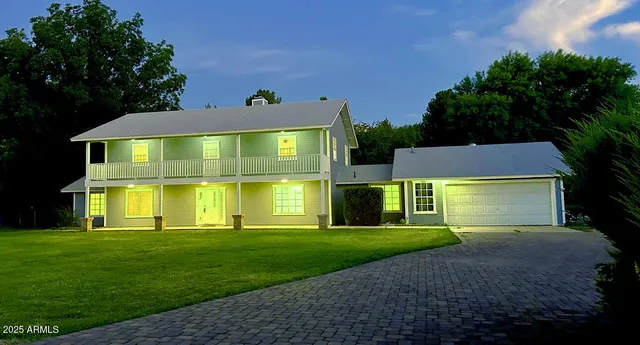 a front view of house with yard and green space