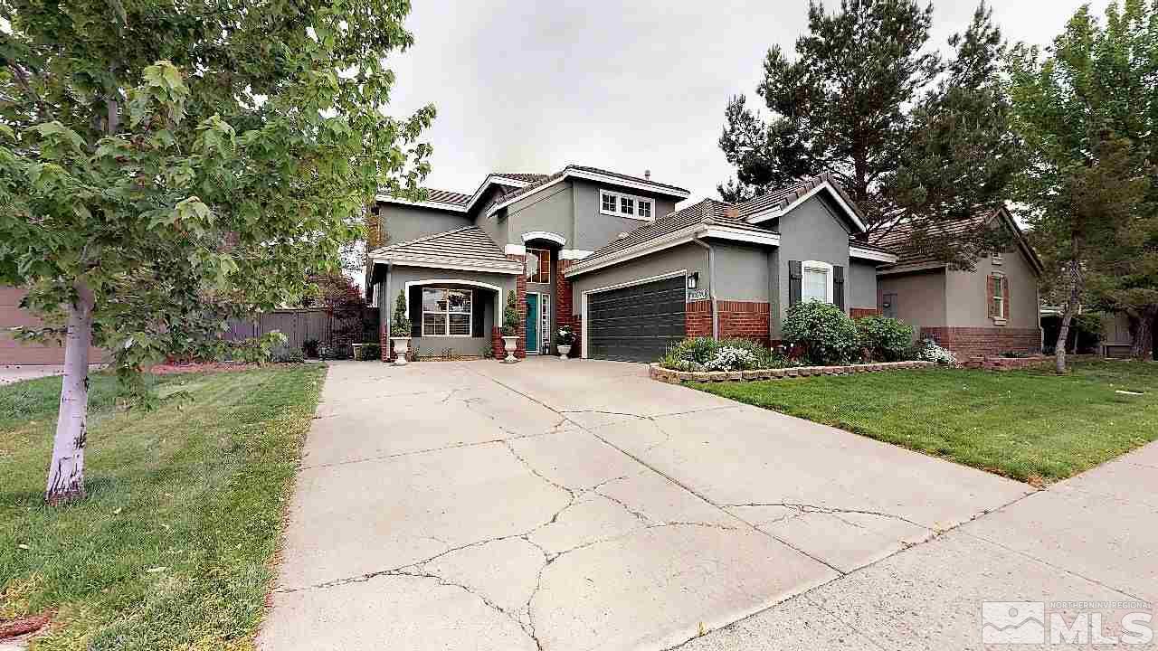 10290 Wolf Ridge Way Reno, NV 89521 - Photo 1 of 22 a front view of house with yard and green space