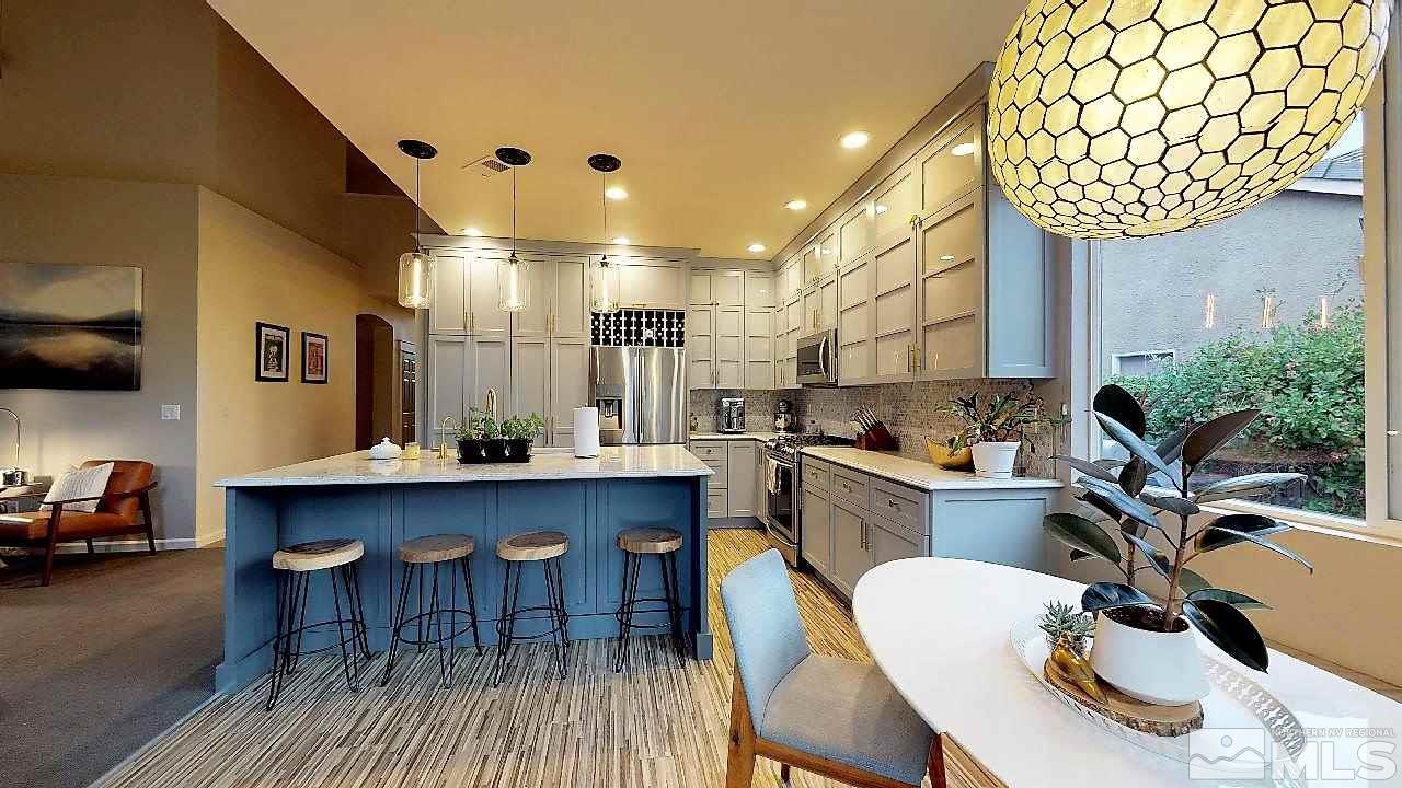 10290 Wolf Ridge Way Reno, NV 89521 - Photo 13 of 22 a kitchen with a sink chairs and cabinets