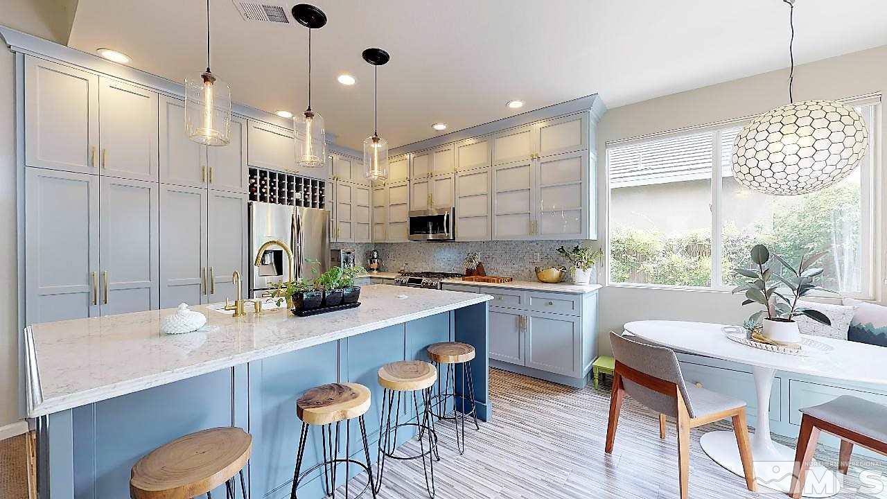 10290 Wolf Ridge Way Reno, NV 89521 - Photo 14 of 22 a kitchen with sink cabinets and wooden floor