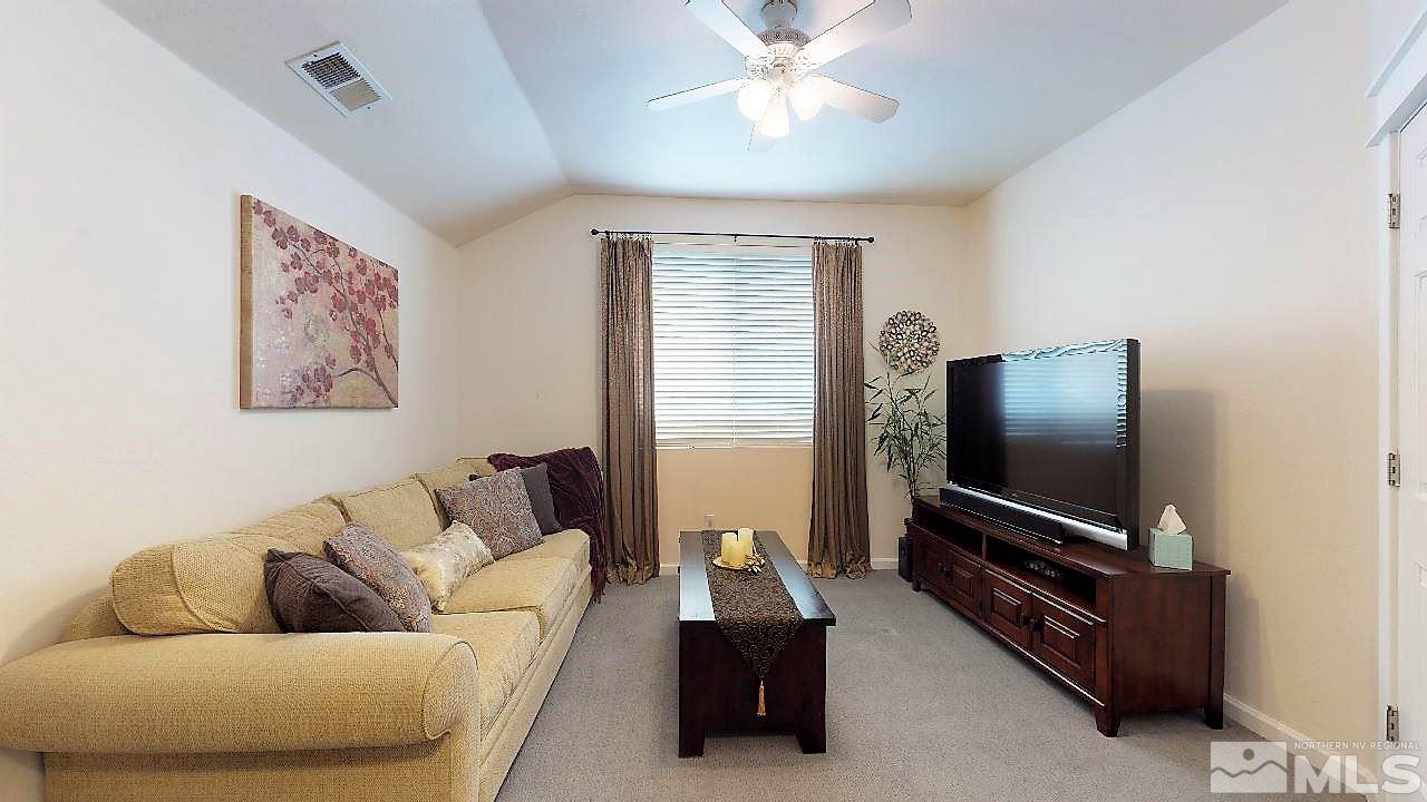 10290 Wolf Ridge Way Reno, NV 89521 - Photo 16 of 22 a living room with furniture and a flat screen tv