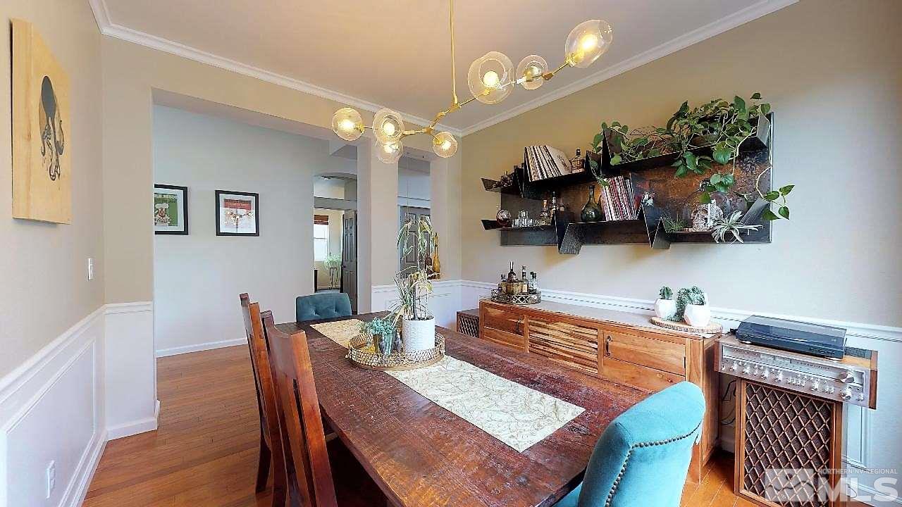 10290 Wolf Ridge Way Reno, NV 89521 - Photo 17 of 22 a dining room filled chandelier and wooden floor
