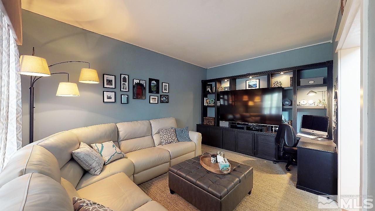 10290 Wolf Ridge Way Reno, NV 89521 - Photo 2 of 22 a living room with furniture and a flat screen tv