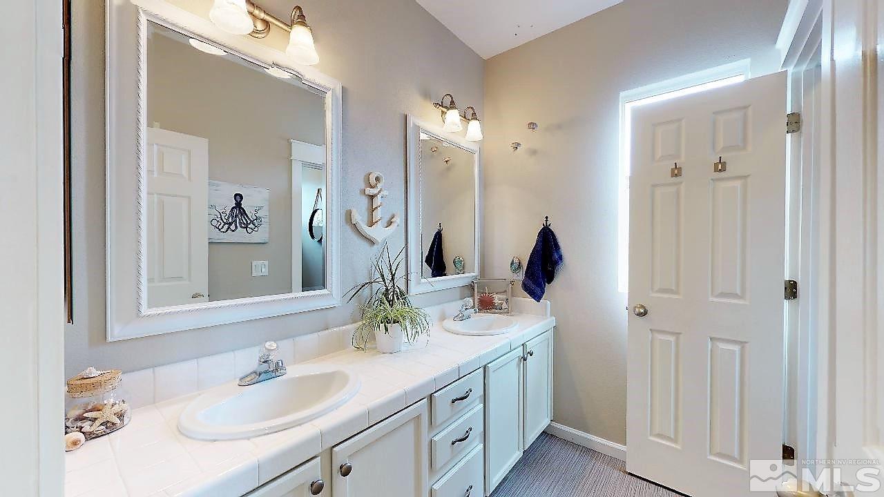 10290 Wolf Ridge Way Reno, NV 89521 - Photo 21 of 22 a bathroom with a double vanity sink mirror and next