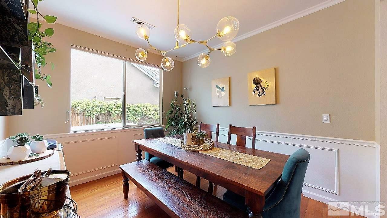 10290 Wolf Ridge Way Reno, NV 89521 - Photo 5 of 22 a view of a dining room with furniture a chandelier and wooden floor