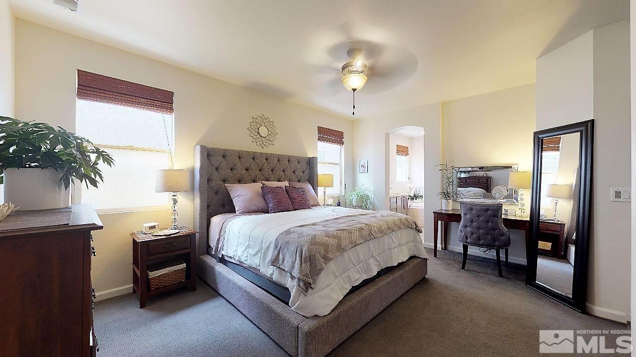 10290 Wolf Ridge Way Reno, NV 89521 - Photo 7 of 22 a bedroom with a bed and a chandelier