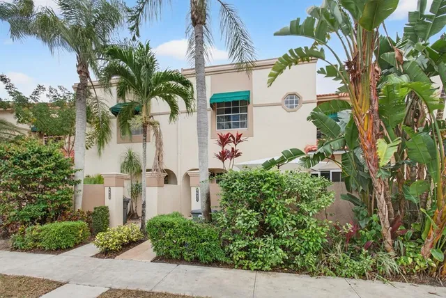 an aerial view of a house with a yard and potted plants