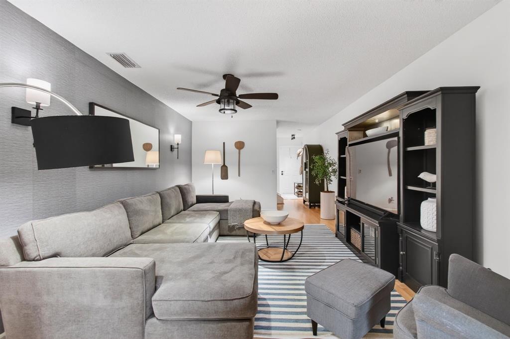 6621 Via Regina, Unit 6621 Boca Raton, FL 33433 - Photo 24 of 100 a living room with furniture and a flat screen tv