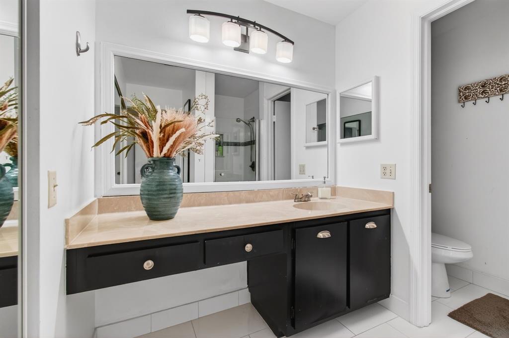 6621 Via Regina, Unit 6621 Boca Raton, FL 33433 - Photo 36 of 100 a bathroom with a granite countertop sink a toilet and mirror