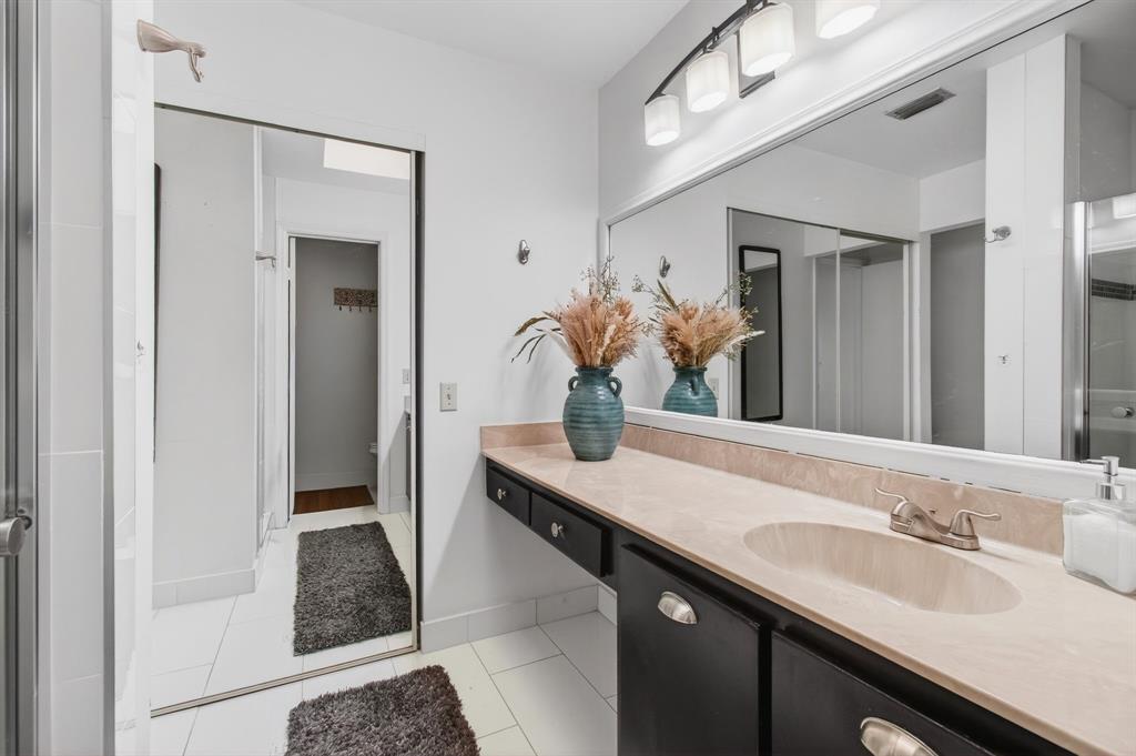 6621 Via Regina, Unit 6621 Boca Raton, FL 33433 - Photo 39 of 100 a bathroom with a granite countertop sink a mirror and a shower