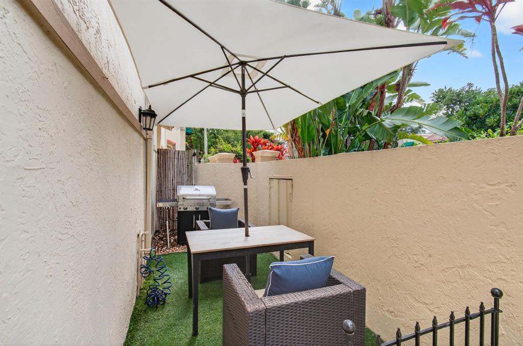 6621 Via Regina, Unit 6621 Boca Raton, FL 33433 - Photo 58 of 100 a table and chairs in the patio