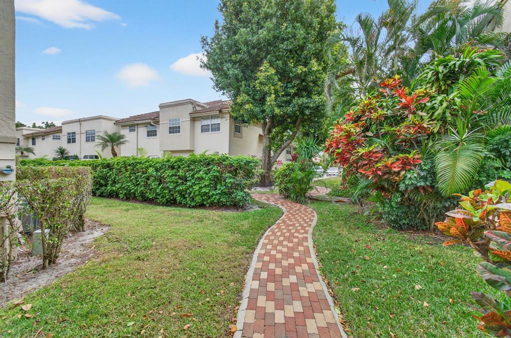 6621 Via Regina, Unit 6621 Boca Raton, FL 33433 - Photo 67 of 100 a view of a pathway with a house in the background