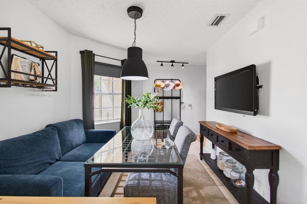 6621 Via Regina, Unit 6621 Boca Raton, FL 33433 - Photo 8 of 100 a living room with furniture and a flat screen tv