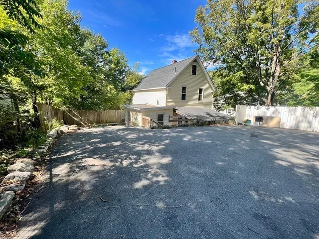 a view of a house with a tree in the background