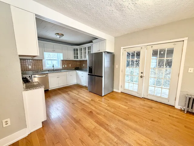 a kitchen with stainless steel appliances granite countertop a refrigerator and a stove top oven