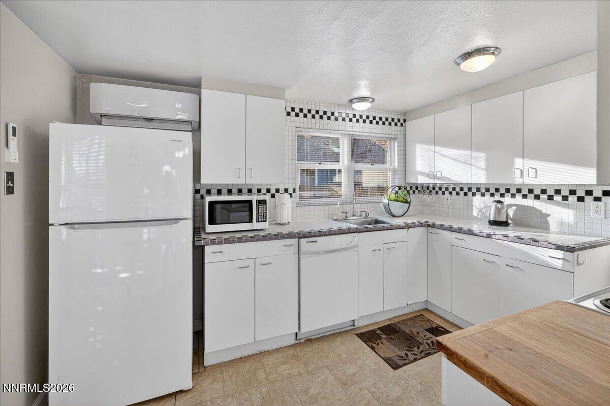 611 Nixon Avenue Reno, NV 89509 - Photo 8 of 43 a kitchen with a refrigerator and a sink