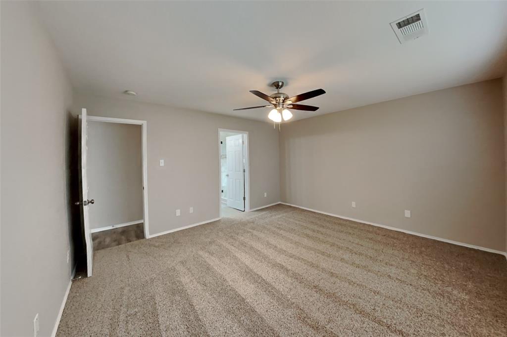 4204 Highgate Road Fort Worth, TX 76244 - Photo 7 of 19 Unfurnished bedroom with light colored carpet, a ceiling fan, and ensuite bath