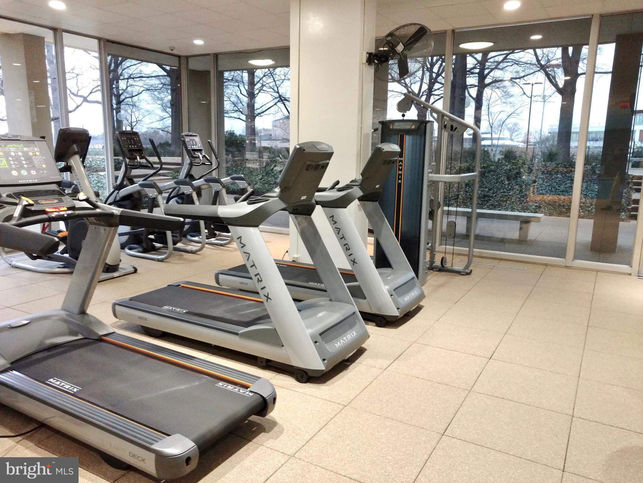 560 N Street Southwest, Unit N304 Washington, DC 20024 - Photo 15 of 22 a room with gym equipment and large mirror