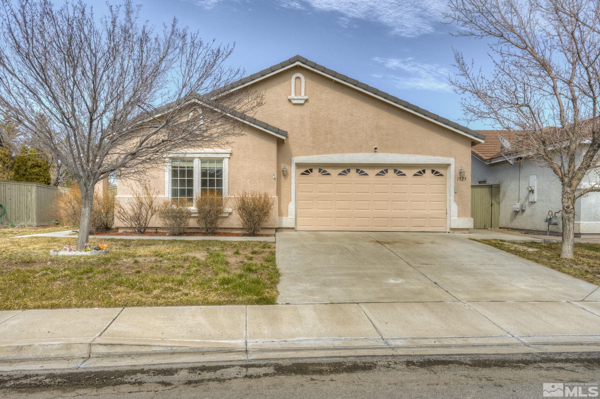 1825 D'Arques Court Reno, NV 89521 - Photo 1 of 40 a front view of a house with garage