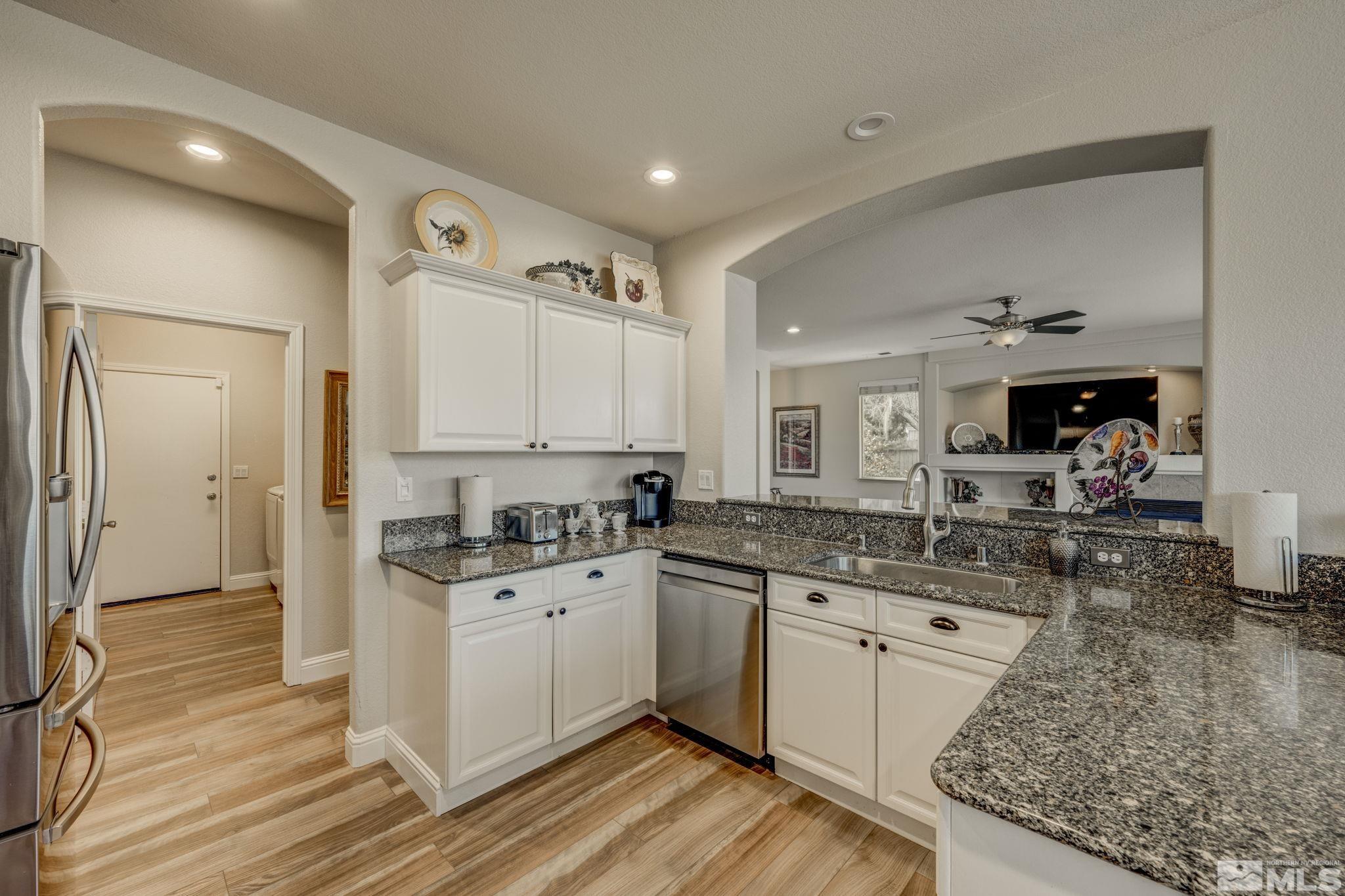 1825 D'Arques Court Reno, NV 89521 - Photo 14 of 40 a kitchen with a sink stove and cabinets