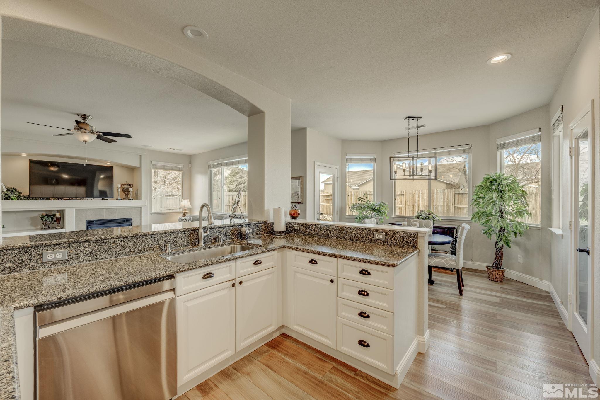 1825 D'Arques Court Reno, NV 89521 - Photo 16 of 40 a kitchen with granite countertop a sink and cabinets