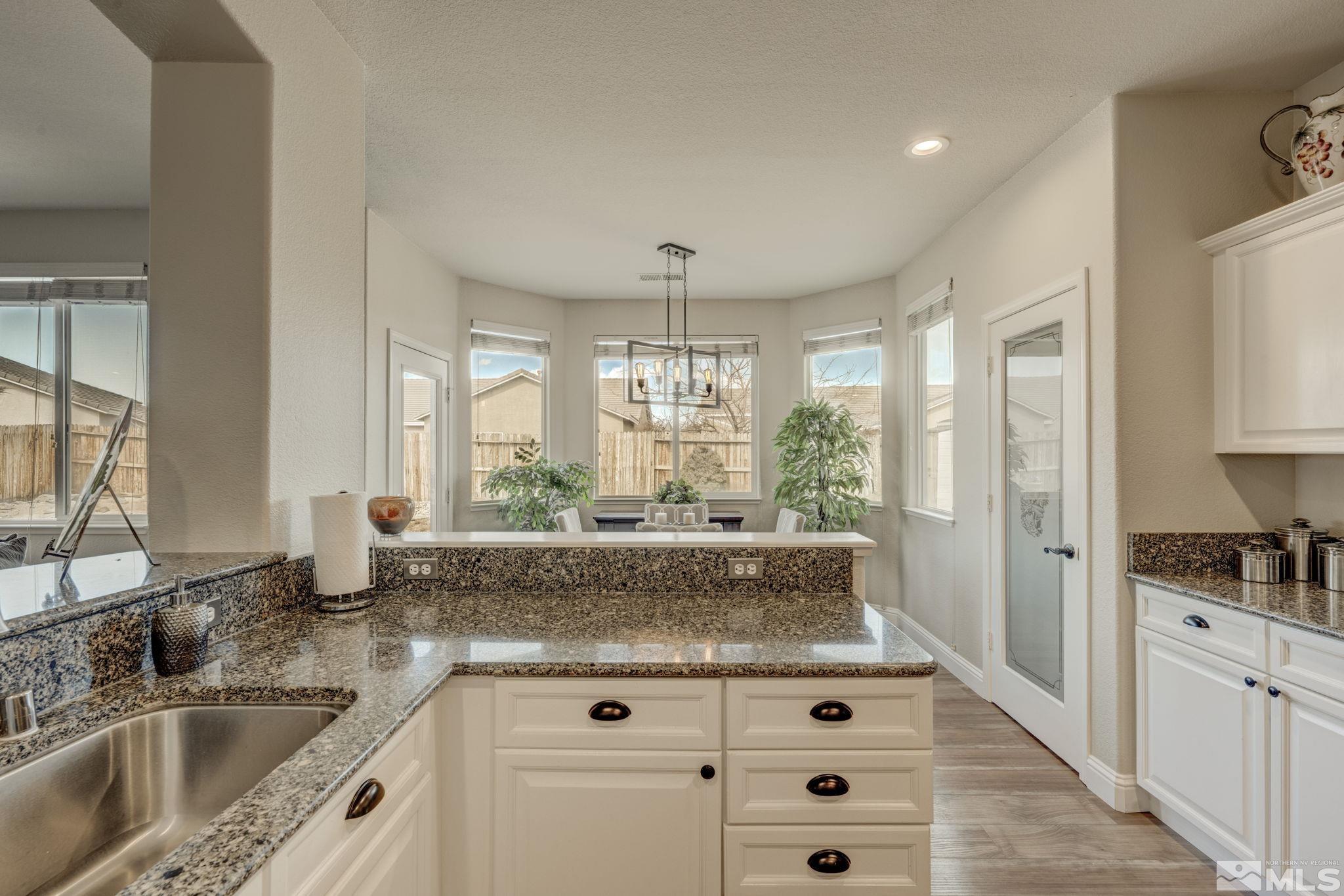 1825 D'Arques Court Reno, NV 89521 - Photo 17 of 40 a kitchen with a stove a sink a refrigerator and a window