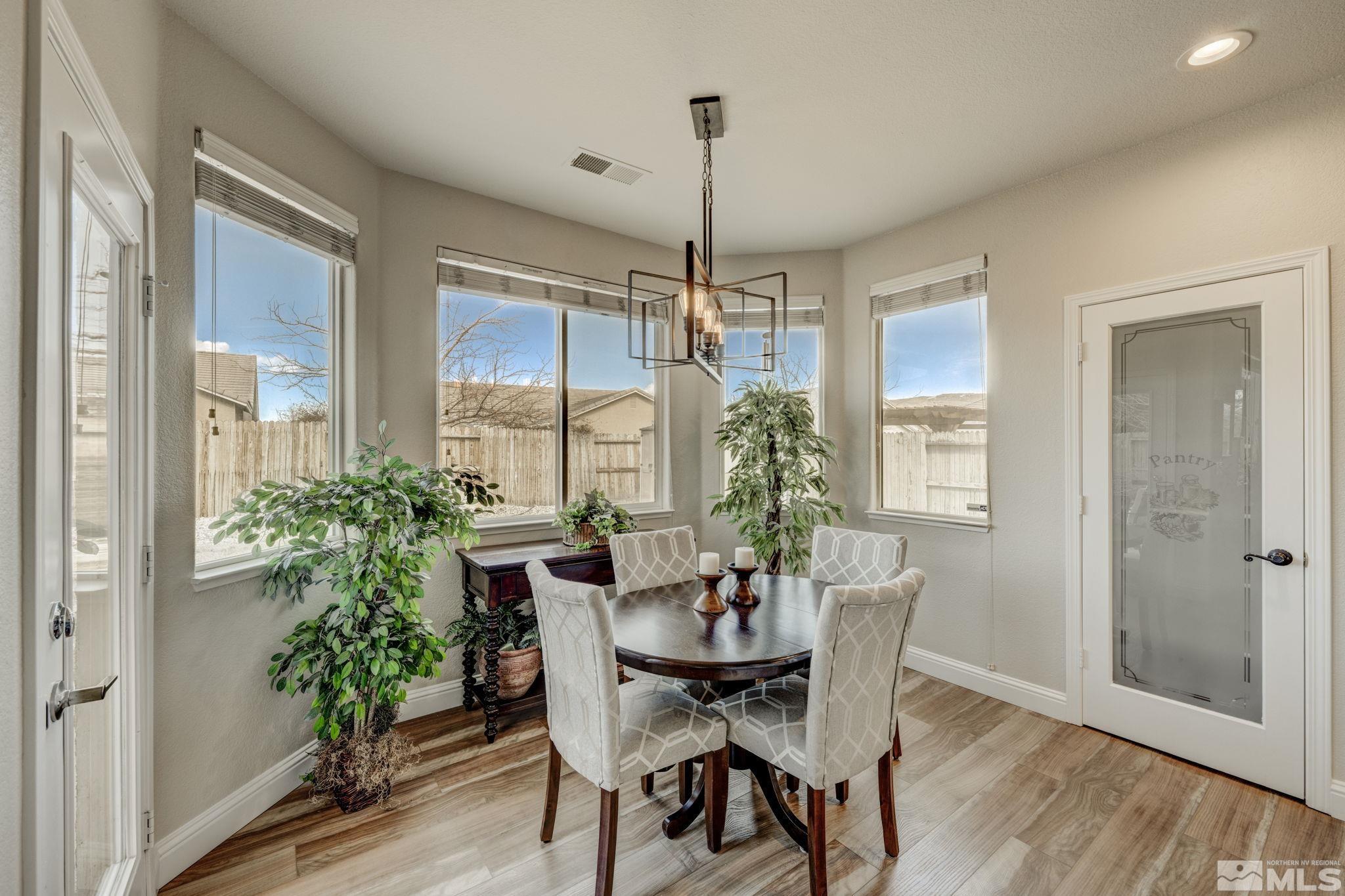 1825 D'Arques Court Reno, NV 89521 - Photo 18 of 40 a dining room with furniture window and wooden floor