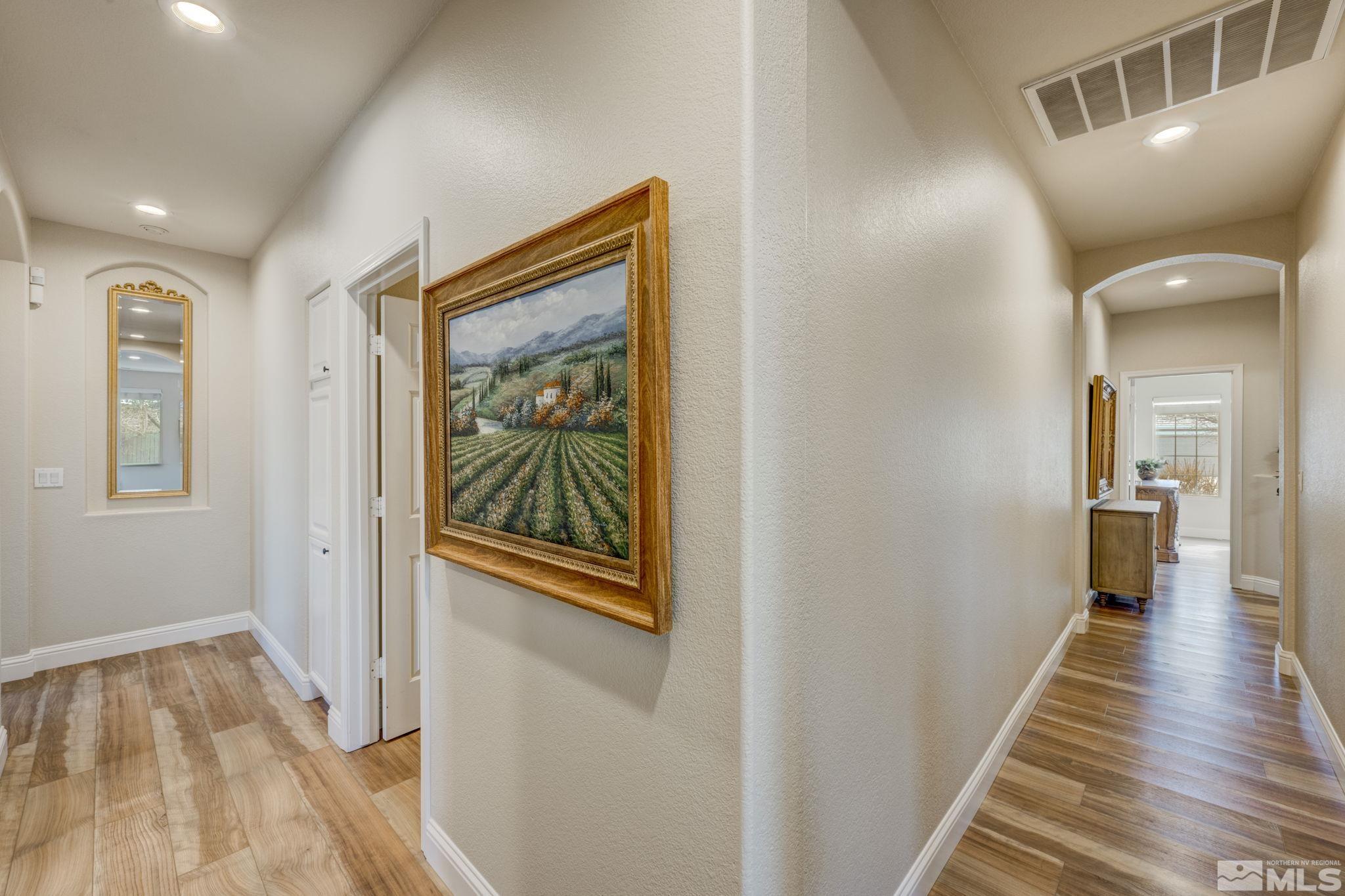 1825 D'Arques Court Reno, NV 89521 - Photo 19 of 40 a view of a hallway with wooden floor and staircase