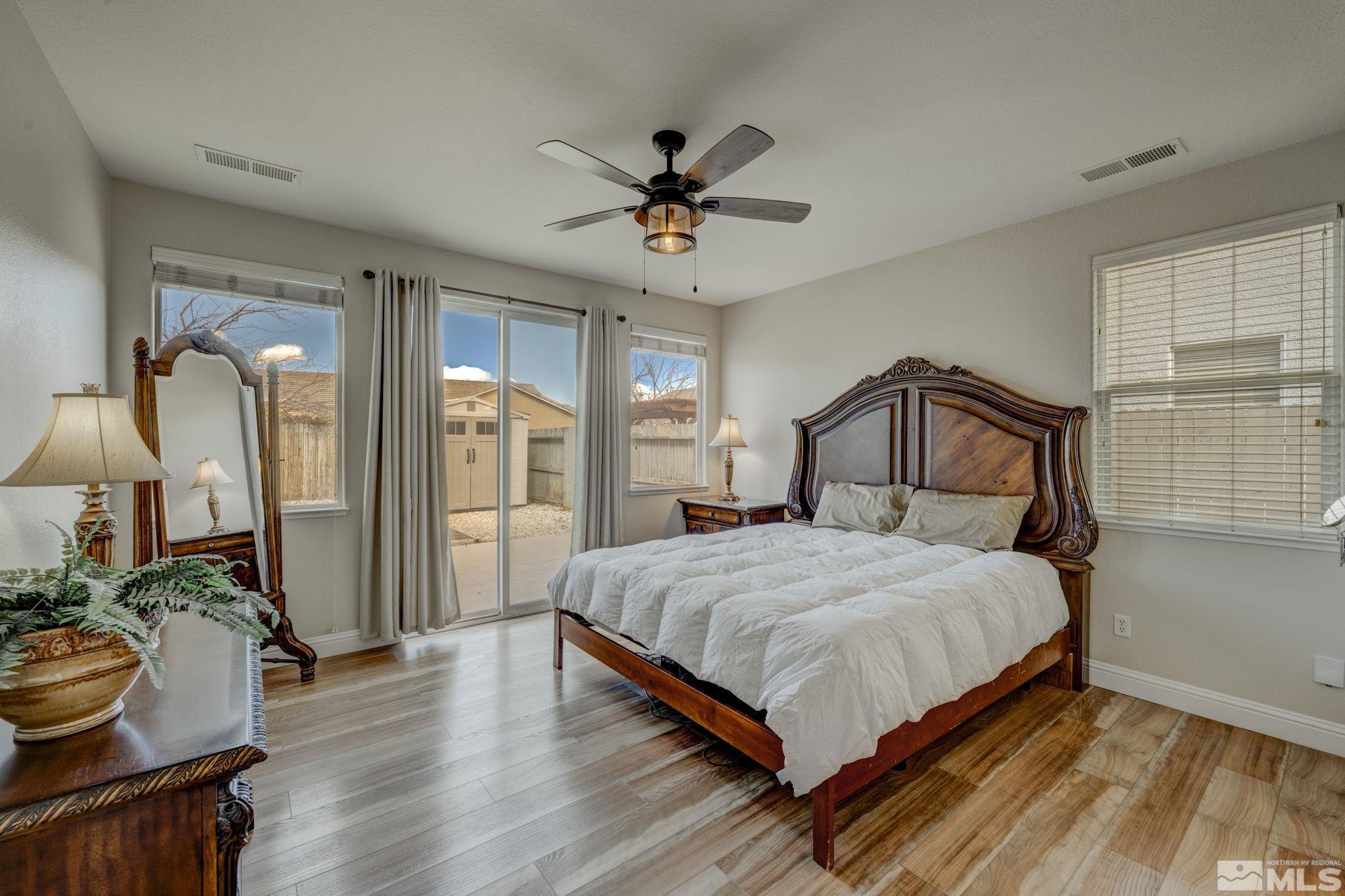 1825 D'Arques Court Reno, NV 89521 - Photo 20 of 40 a bedroom with a bed a window and potted plant on the dresser