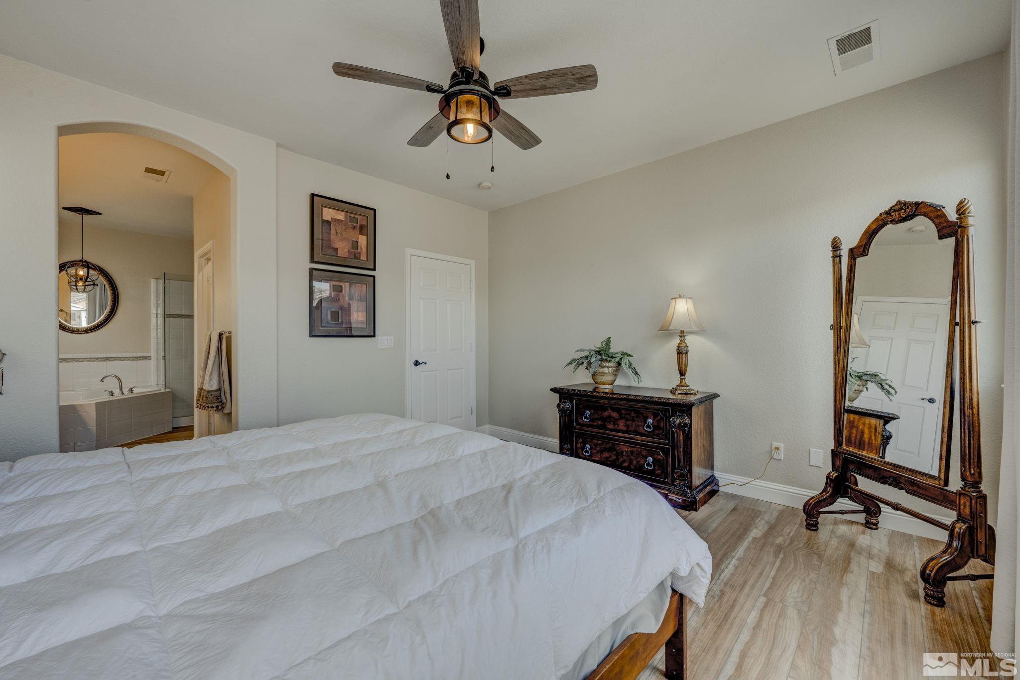 1825 D'Arques Court Reno, NV 89521 - Photo 21 of 40 a bedroom with a bed and wooden floor