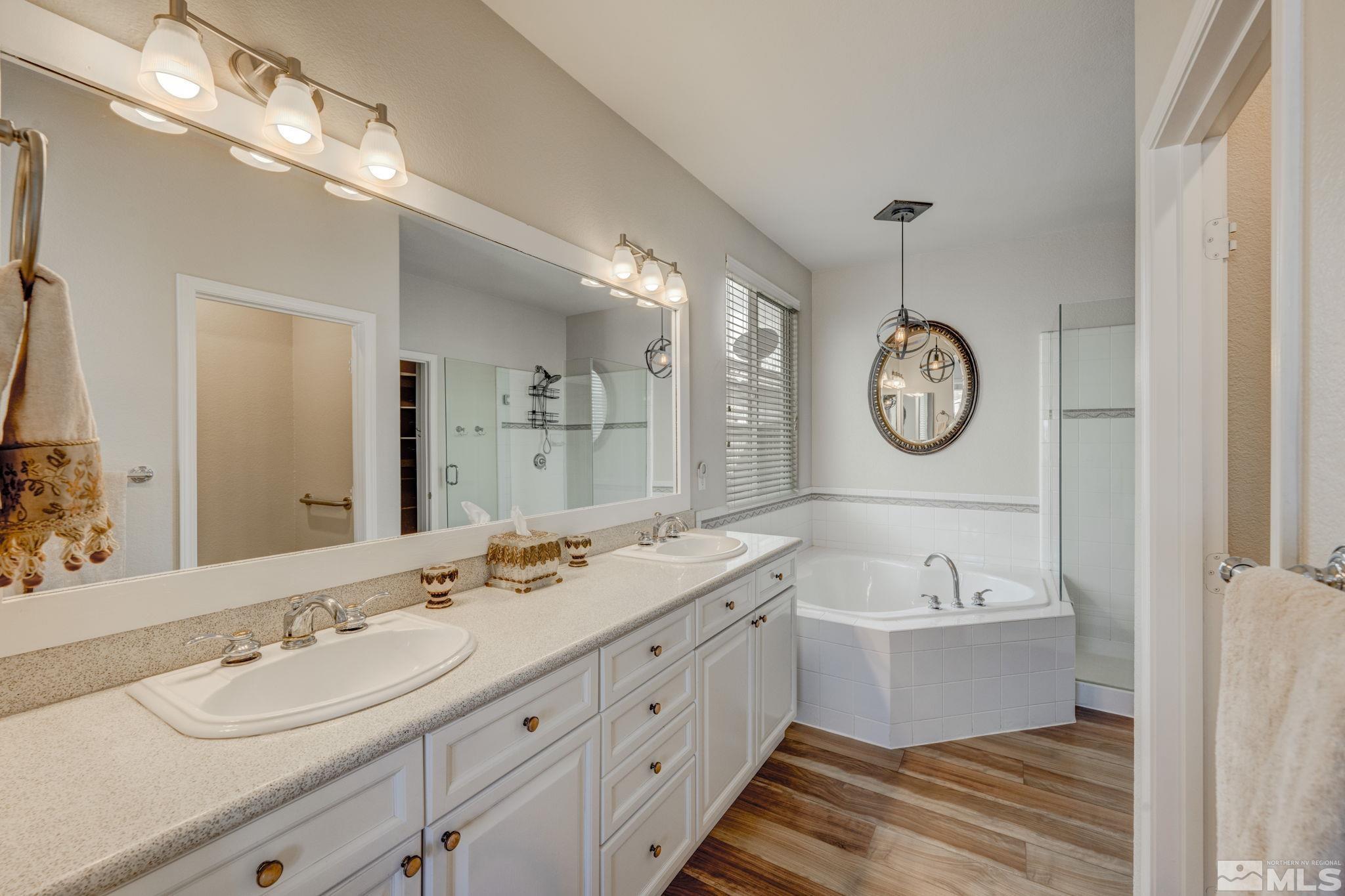 1825 D'Arques Court Reno, NV 89521 - Photo 22 of 40 a spacious bathroom with a double vanity sink mirror and bathtub
