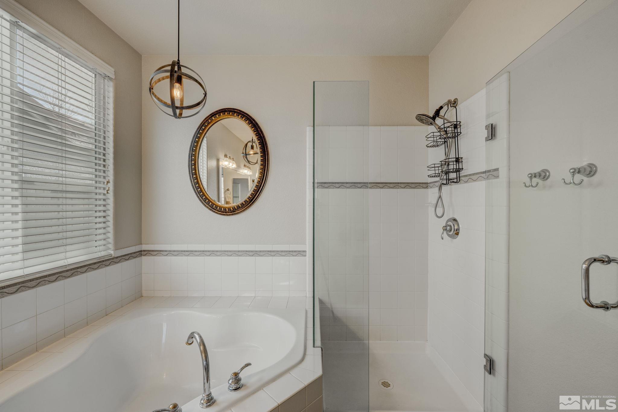 1825 D'Arques Court Reno, NV 89521 - Photo 25 of 40 a bathroom with a bathtub and a shower