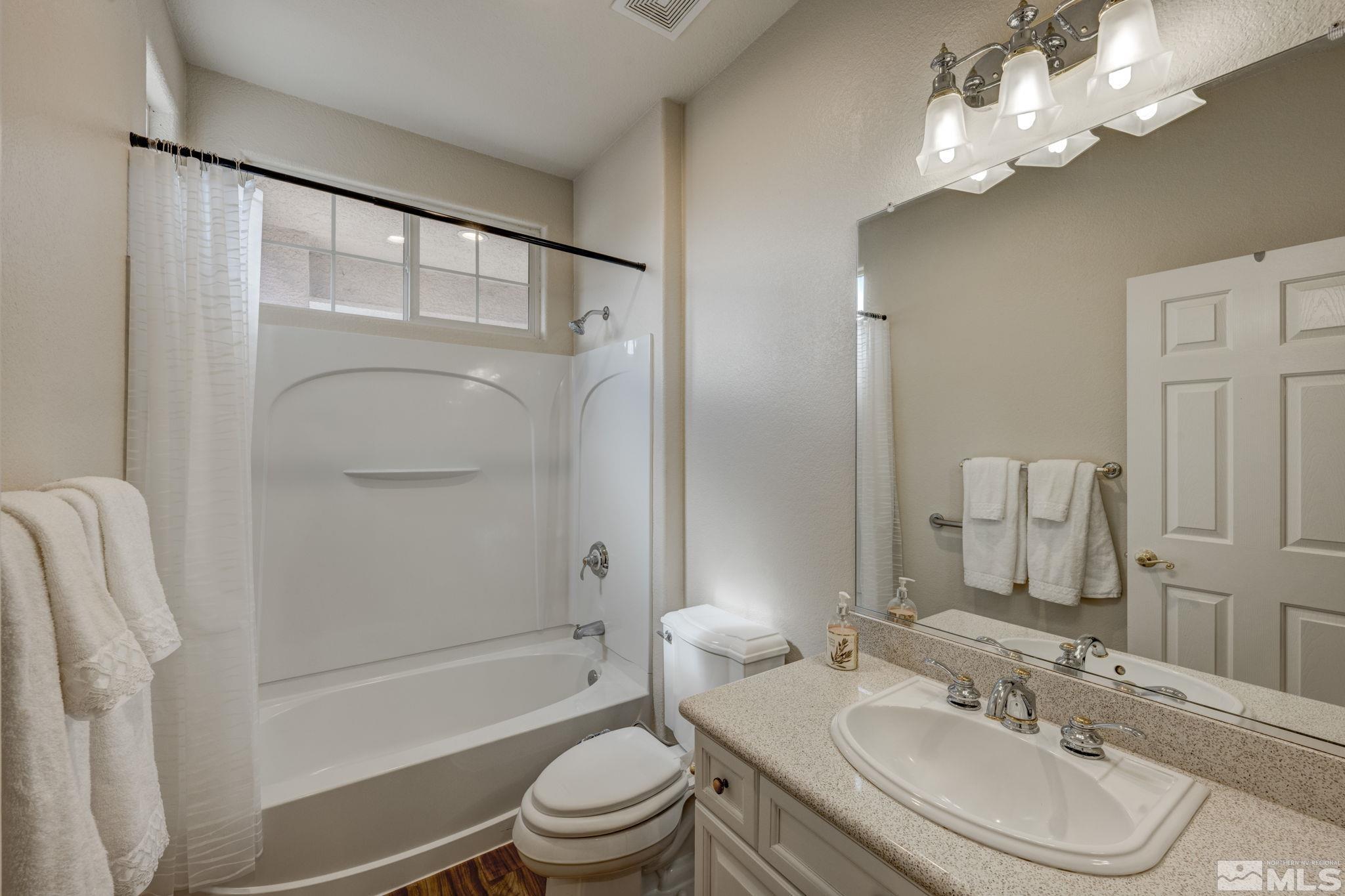1825 D'Arques Court Reno, NV 89521 - Photo 28 of 40 a bathroom with a sink a toilet and shower