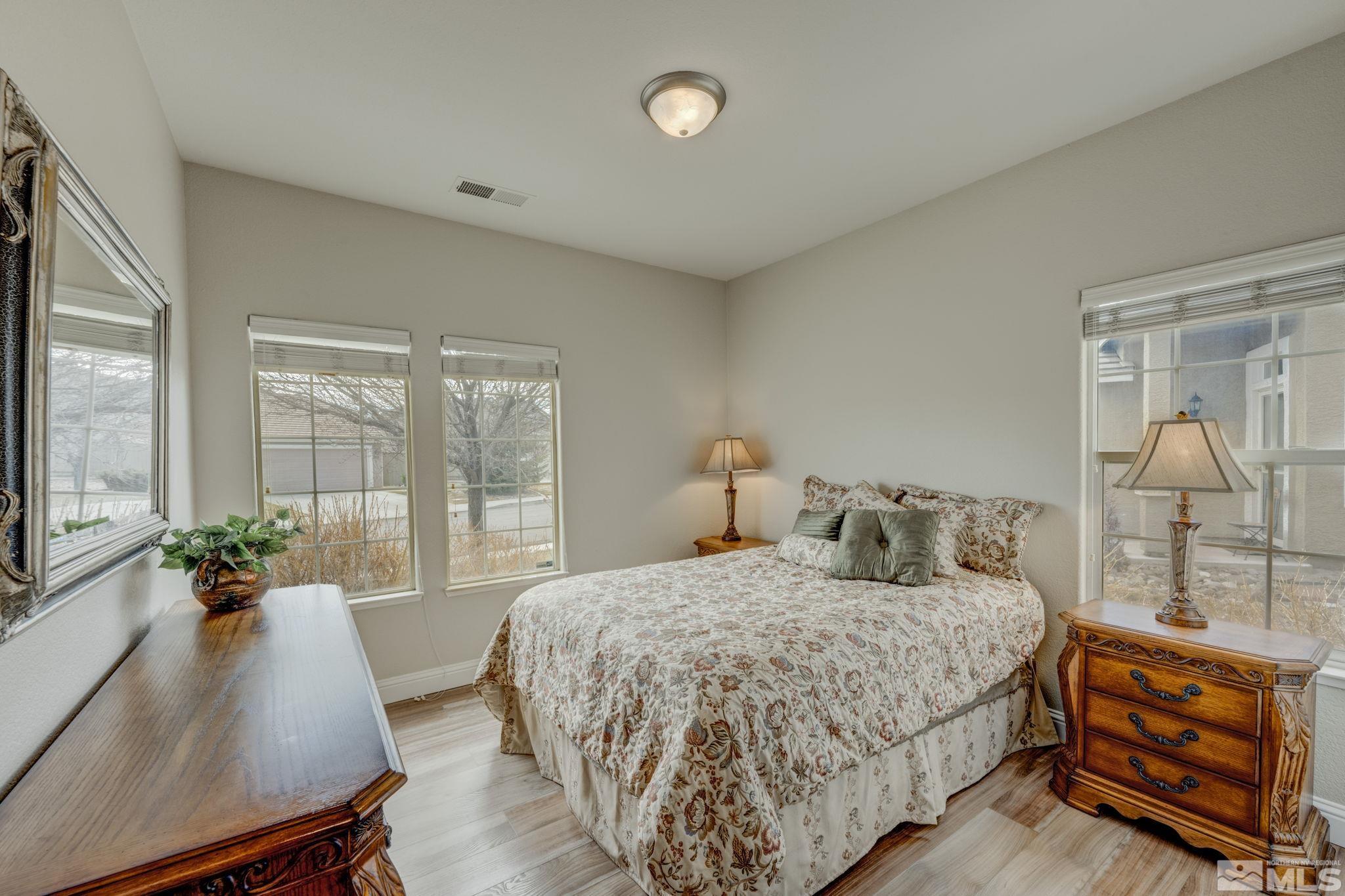 1825 D'Arques Court Reno, NV 89521 - Photo 29 of 40 a bedroom with a bed and large windows