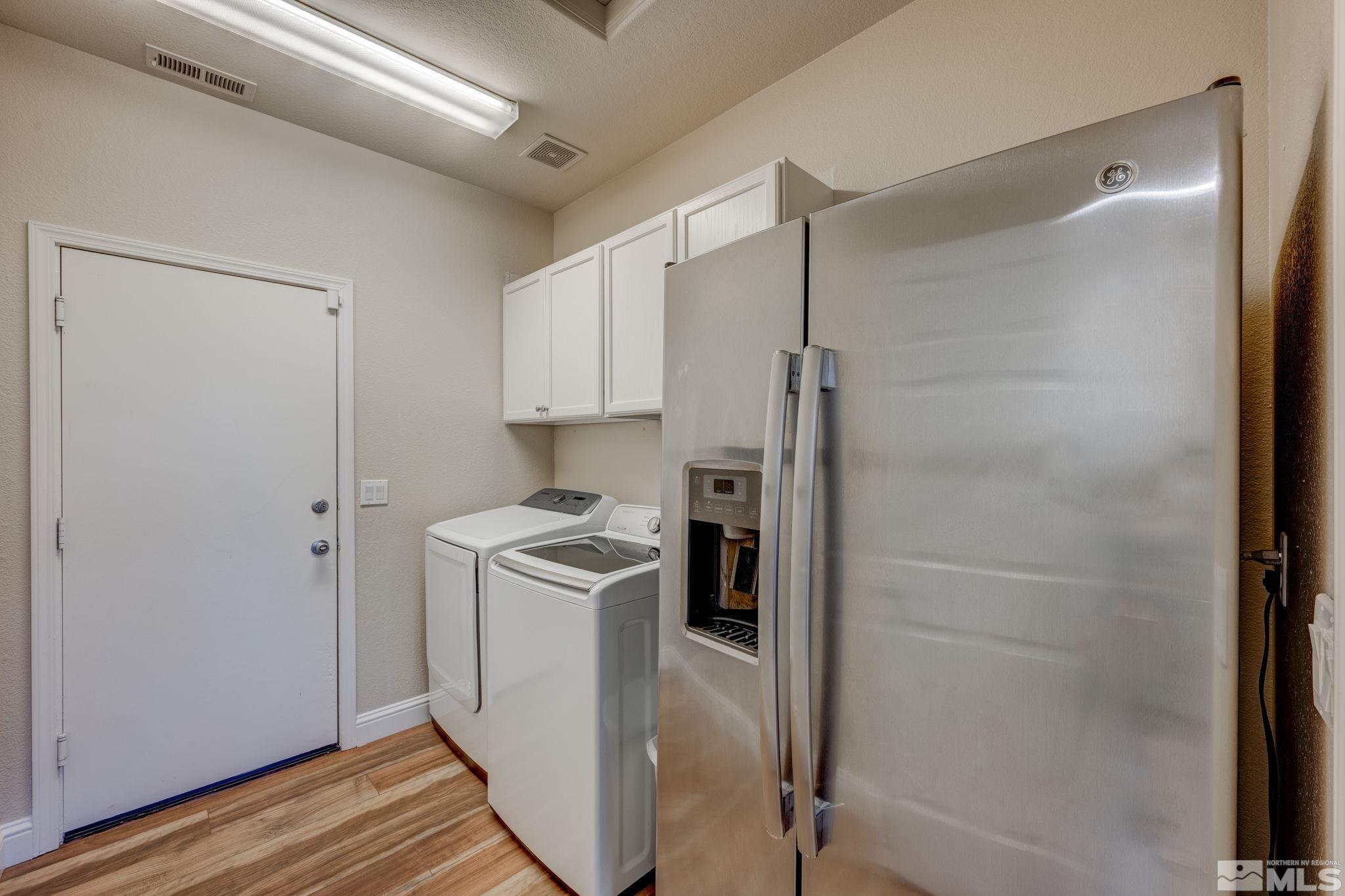 1825 D'Arques Court Reno, NV 89521 - Photo 31 of 40 a kitchen with a refrigerator a stove and wooden floor