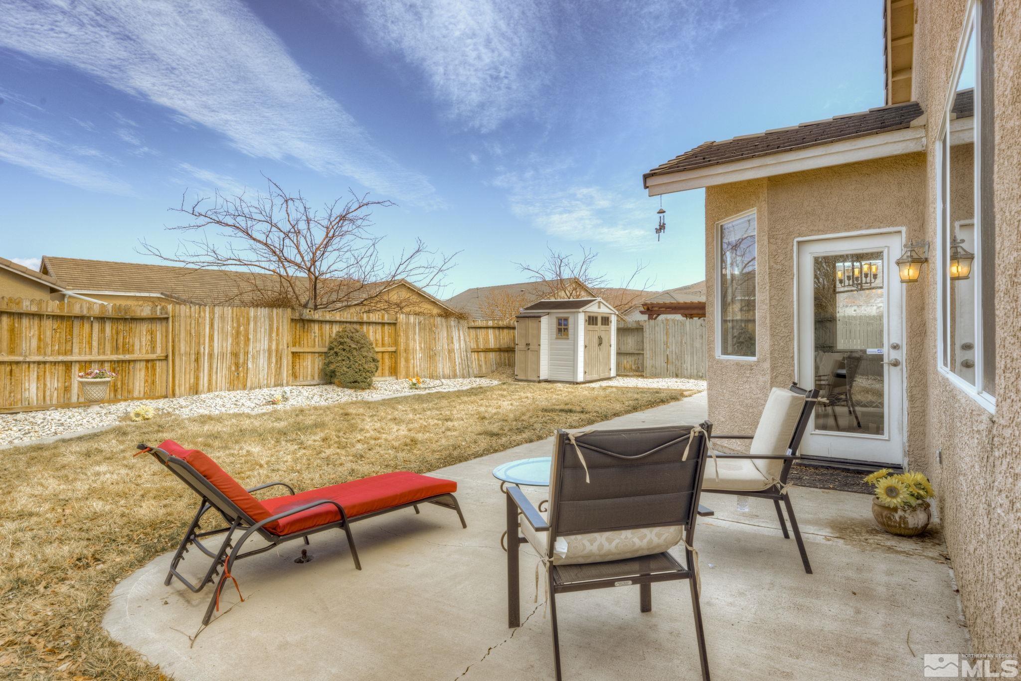 1825 D'Arques Court Reno, NV 89521 - Photo 35 of 40 a view of a dinning table and chairs in the patio