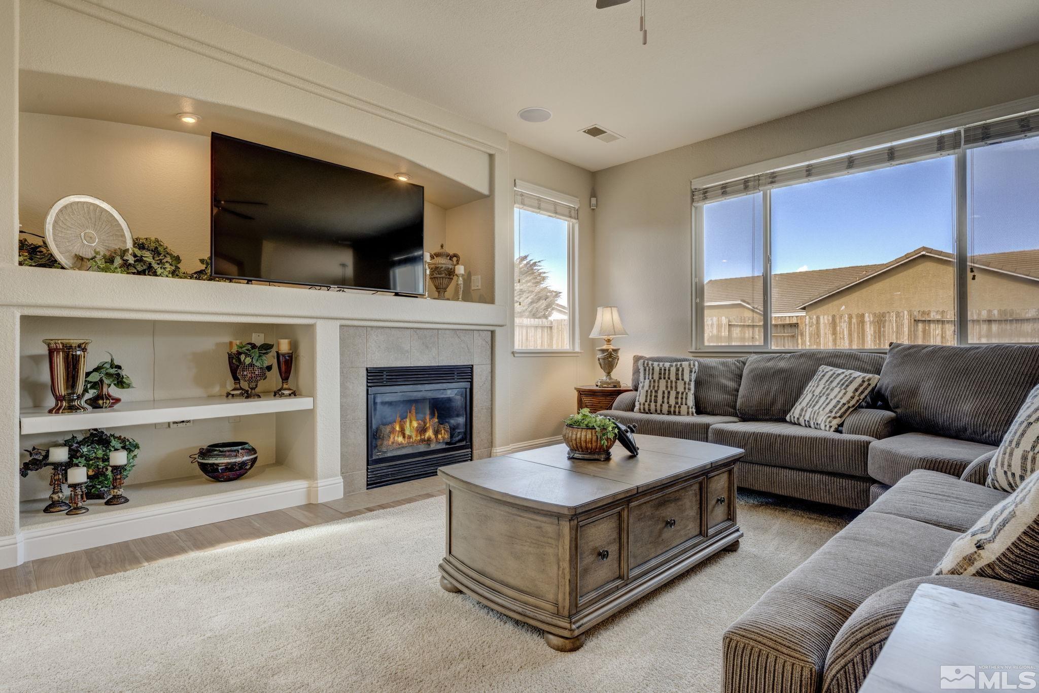 1825 D'Arques Court Reno, NV 89521 - Photo 8 of 40 a living room with furniture and a fireplace